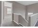 Upstairs hallway features neutral paint, carpet, and open door into another room at 281 Dovetree Dr, Danville, IN 46122