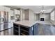 Open-concept kitchen featuring stainless steel appliances and a navy blue island with quartz countertop at 281 Dovetree Dr, Danville, IN 46122