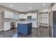 Spacious kitchen with white cabinets, stainless steel appliances, and a navy blue island at 281 Dovetree Dr, Danville, IN 46122