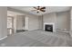 Comfortable living room showcasing plush gray carpet and a cozy fireplace, creating a warm and inviting atmosphere at 281 Dovetree Dr, Danville, IN 46122