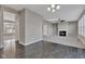 Expansive living room area with a cozy fireplace, flowing from hardwood to carpet at 281 Dovetree Dr, Danville, IN 46122
