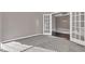 A view of a carpeted office space with french doors, and neutral colored walls offering a serene atmosphere at 281 Dovetree Dr, Danville, IN 46122