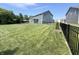 Large backyard features a well-manicured lawn, privacy fence, and a patio with outdoor furniture for relaxation at 3535 Merchmont Rd, Bargersville, IN 46106