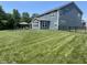 Spacious backyard features a well-manicured lawn, black fence, and a patio with outdoor furniture for entertaining at 3535 Merchmont Rd, Bargersville, IN 46106