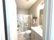 Bright bathroom boasts a glass-enclosed shower, vanity with countertop, and modern sink, all bathed in natural light at 3535 Merchmont Rd, Bargersville, IN 46106