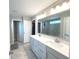 Bright bathroom boasts double sinks, quartz countertops, and a large mirror above the vanity at 3535 Merchmont Rd, Bargersville, IN 46106