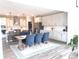Dining area featuring a wooden table with blue upholstered chairs, with open view to kitchen and stainless steel appliances at 3535 Merchmont Rd, Bargersville, IN 46106