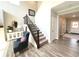 Inviting entryway with hardwood floors, elegant staircase, and comfortable sitting area creating a warm and welcoming ambiance at 3535 Merchmont Rd, Bargersville, IN 46106