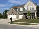 Charming two-story home boasts a brick and siding exterior, three-car garage and a well-maintained lawn at 3535 Merchmont Rd, Bargersville, IN 46106