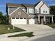 Charming two-story home boasts a brick and siding exterior, three-car garage and a well-manicured lawn at 3535 Merchmont Rd, Bargersville, IN 46106