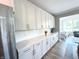 A modern kitchen features stainless steel appliances and sleek white cabinets with plenty of storage space at 3535 Merchmont Rd, Bargersville, IN 46106