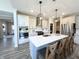 Bright kitchen with large island, pendant lighting, stainless appliances, and bar stool seating for casual dining at 3535 Merchmont Rd, Bargersville, IN 46106