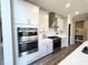 A stylish kitchen features stainless steel appliances, a gas range, and a contemporary vent hood at 3535 Merchmont Rd, Bargersville, IN 46106