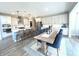 Open-concept kitchen featuring white cabinetry, stainless steel appliances, and a large kitchen island with barstool seating at 3535 Merchmont Rd, Bargersville, IN 46106
