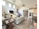 Open-concept living area featuring a fireplace, hardwood floors, and a seamless flow to the kitchen and dining space at 3535 Merchmont Rd, Bargersville, IN 46106