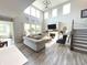 Bright, open living room with high ceilings, large windows, hardwood floors, modern fireplace, and elegant furnishings at 3535 Merchmont Rd, Bargersville, IN 46106