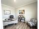 Stylish home office with light grey walls, wood floors, and decorative shelving at 3535 Merchmont Rd, Bargersville, IN 46106