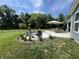 Inviting patio area features comfortable seating around a fire pit, a dining table with an umbrella, and a built-in grill at 3535 Merchmont Rd, Bargersville, IN 46106