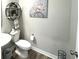 Charming powder room with decorative shelf, toilet, sink, and wood-look flooring at 3535 Merchmont Rd, Bargersville, IN 46106