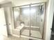 Modern shower features glass doors, a built-in bench, and elegant tile work, offering a spa-like experience at 3535 Merchmont Rd, Bargersville, IN 46106