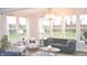 Bright sunroom with large windows, comfortable seating, and neutral color scheme creating a relaxing and inviting atmosphere at 3535 Merchmont Rd, Bargersville, IN 46106