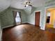 Bedroom with vintage hard wood floors, natural light, and ceiling fan at 367 W Broadway St, Shelbyville, IN 46176