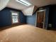 Bedroom features a blue wallpaper, skylight, small window and a wooden door at 367 W Broadway St, Shelbyville, IN 46176