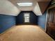 Bedroom has a slanted ceiling, skylight, blue wallpaper and a small window at 367 W Broadway St, Shelbyville, IN 46176