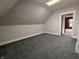 Empty bedroom features a blue carpet, light gray walls, and an open doorway at 367 W Broadway St, Shelbyville, IN 46176