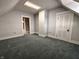 Empty bedroom has a blue carpet, light gray walls, skylight, and a white door at 367 W Broadway St, Shelbyville, IN 46176