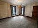 Serene bedroom featuring carpeted floors, neutral walls, natural light, and classic trim at 367 W Broadway St, Shelbyville, IN 46176