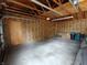 Spacious garage with exposed insulation and unfinished ceiling and concrete floor at 367 W Broadway St, Shelbyville, IN 46176