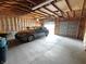 Garage with a gray sedan in it and exposed unfinished walls and ceiling at 367 W Broadway St, Shelbyville, IN 46176