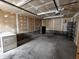 Spacious garage with concrete floor, storage racks, and washing machine at 367 W Broadway St, Shelbyville, IN 46176