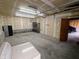 View of the garage area showcasing metal shelves and door to the outside at 367 W Broadway St, Shelbyville, IN 46176