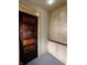 Hallway with vintage dark-stained wood door and built-in storage shelves at 367 W Broadway St, Shelbyville, IN 46176