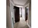 Carpeted hallway showcasing a hallway to a bedroom at 367 W Broadway St, Shelbyville, IN 46176