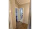A hallway offers views into an attic bedroom, with rainbow wallpaper, and bathroom at 367 W Broadway St, Shelbyville, IN 46176