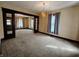 Inviting living room with classic lighting, cozy carpet, and elegant architectural details at 367 W Broadway St, Shelbyville, IN 46176