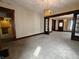 Bright living room with stylish lighting fixtures, neutral carpet, and decorative entryways at 367 W Broadway St, Shelbyville, IN 46176