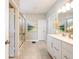 Bright bathroom featuring a double vanity, tile floors, and glass shower enclosure at 3865 Kensington Dr, Danville, IN 46122