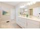 Bright bathroom featuring a double vanity, tile floors, a modern mirror and hardware at 3865 Kensington Dr, Danville, IN 46122