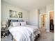 Comfortable bedroom with a large window, carpet, wooden furnishings, and attached en-suite bathroom at 3865 Kensington Dr, Danville, IN 46122