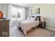 Well-lit bedroom with large window, carpet, wooden furnishings, and a serene, inviting atmosphere at 3865 Kensington Dr, Danville, IN 46122