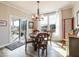 Bright dining area with sliding doors to backyard, hardwood floors, an elegant chandelier and comfortable seating at 3865 Kensington Dr, Danville, IN 46122