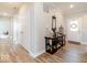 Open entryway with hardwood floors, table decor and easy access to other rooms at 3865 Kensington Dr, Danville, IN 46122