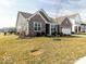 Brick home showing the side and front with a manicured lawn and partial driveway view at 3865 Kensington Dr, Danville, IN 46122