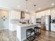 Bright eat-in kitchen with an island, stainless appliances, pendant lighting, and a full complement of modern amenities at 3865 Kensington Dr, Danville, IN 46122