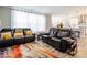 Living room with large windows, comfortable seating, and an open layout leading to kitchen at 3865 Kensington Dr, Danville, IN 46122