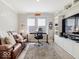 Comfortable office featuring a brown leather couch, desk, and built-in shelving at 3865 Kensington Dr, Danville, IN 46122